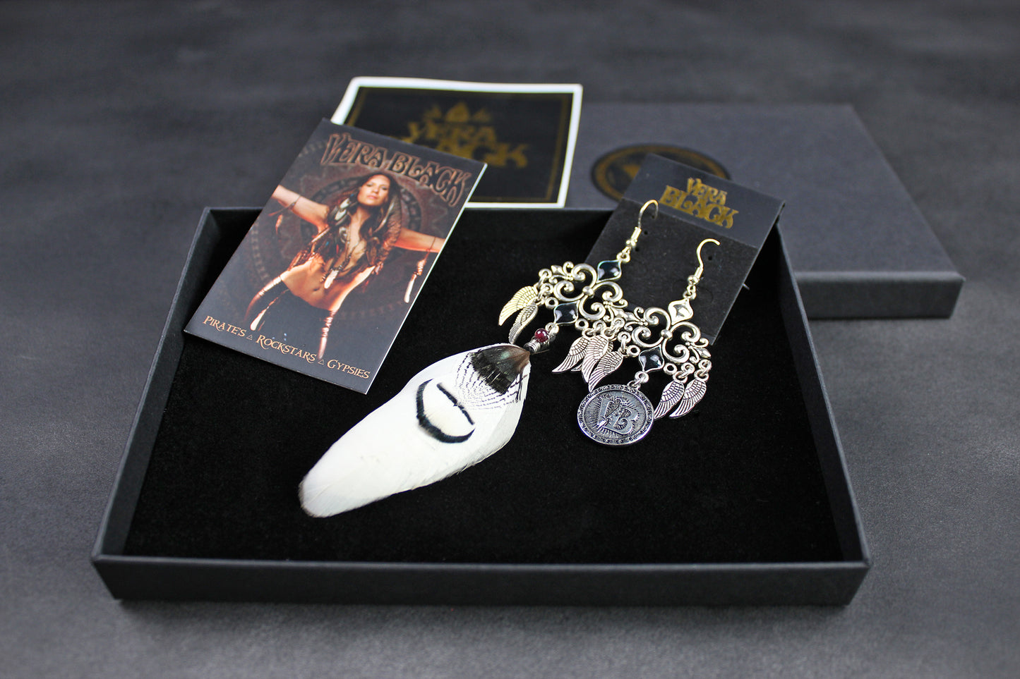 Earring set with packaging on a dark surface