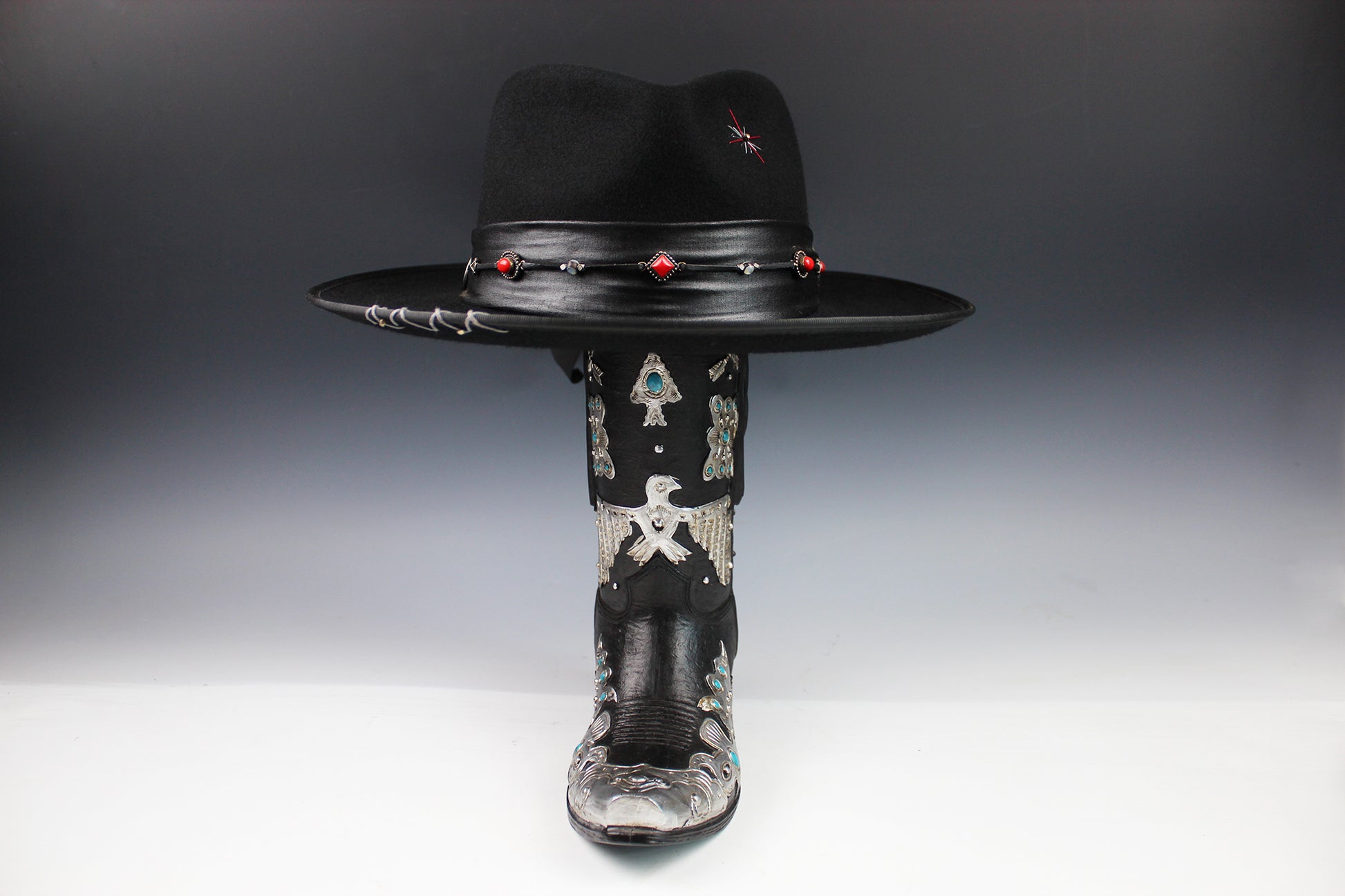 Black cowboy hat with decorative elements on a gray background