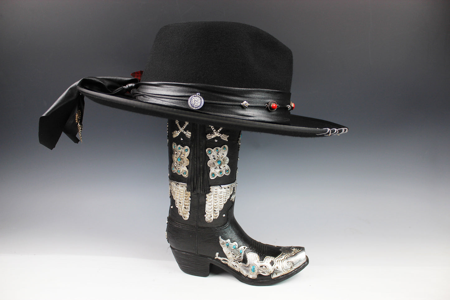 Black cowboy hat with decorative elements on a gray background