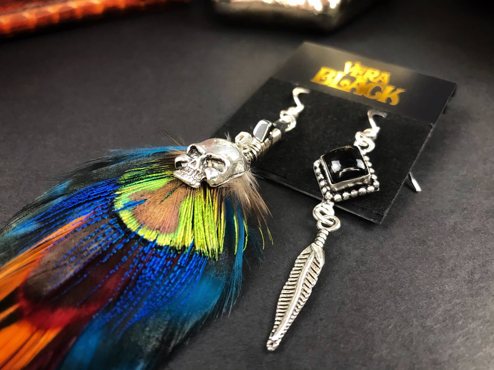 Teal Feather Silver Skull Earrings - rock n roll silver skull feather earrings with black onyx stone