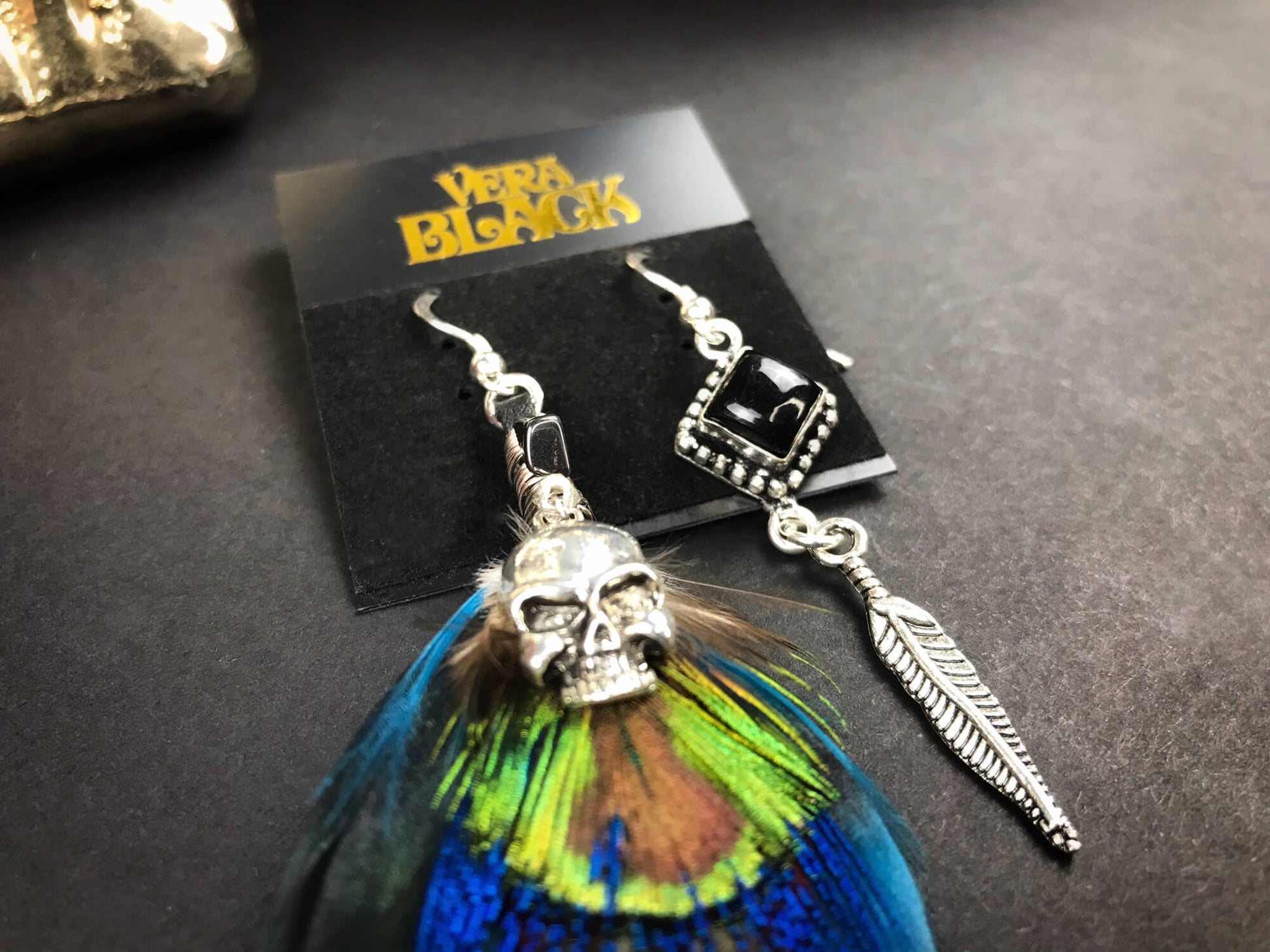 Teal Feather Silver Skull Earrings - rock n roll silver skull feather earrings with black onyx stone