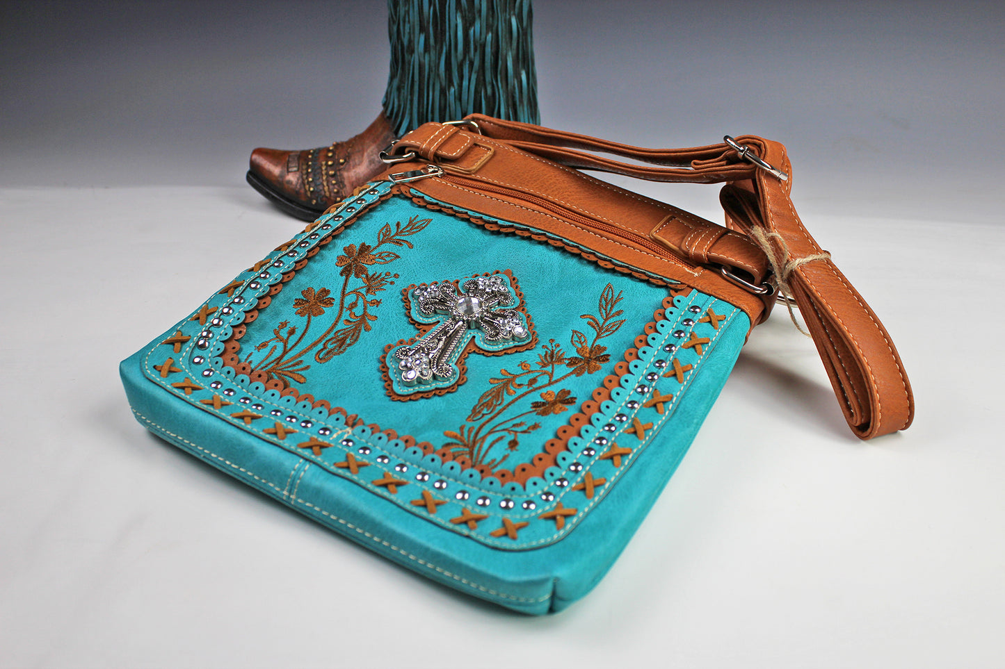 The Montana Shoulder Bag - turquoise & brown western cowgirl style bag with intricate detailing and cross motif with an internal zip pocket