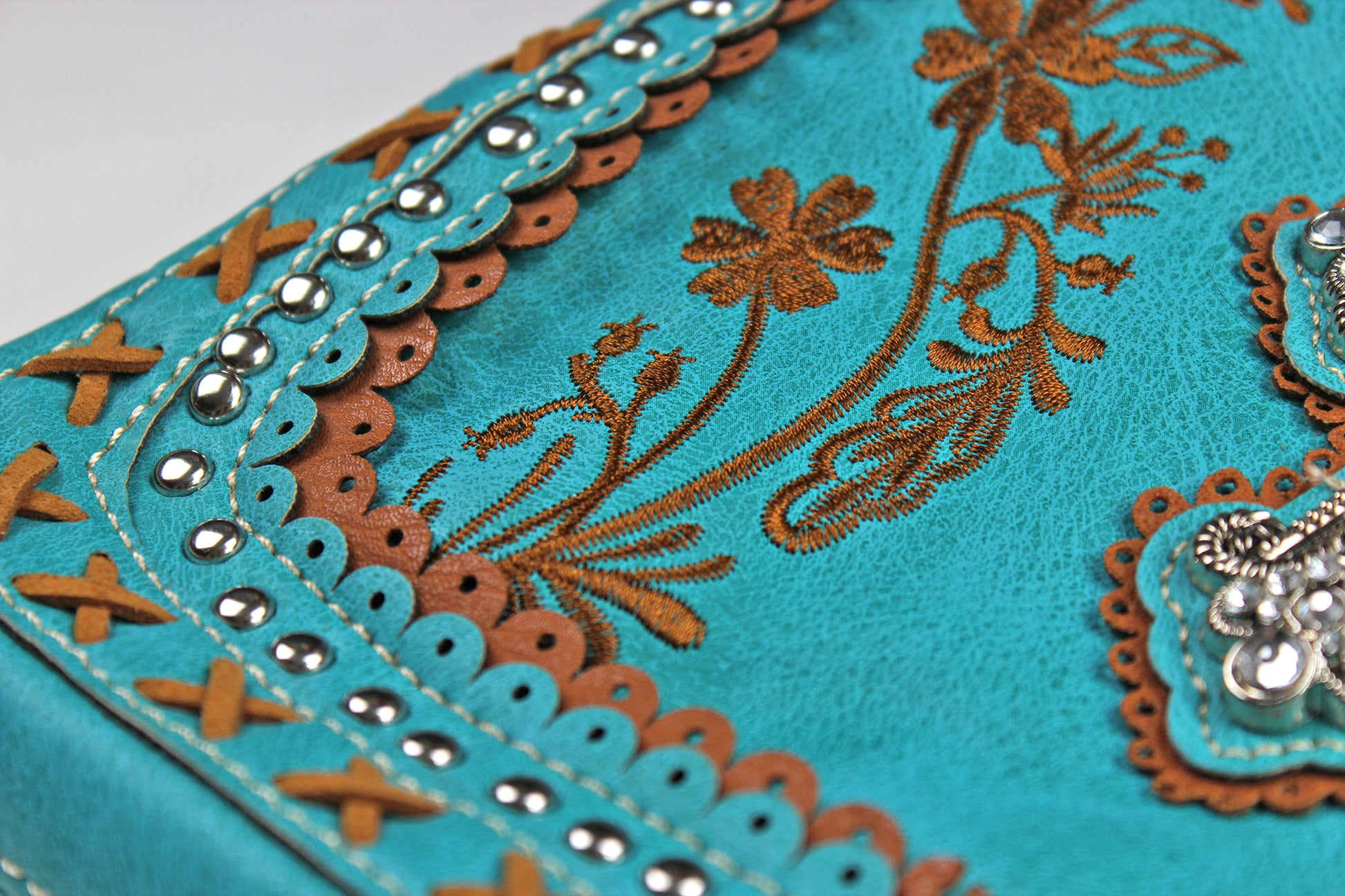 The Montana Shoulder Bag - turquoise & brown western cowgirl style bag with intricate detailing and cross motif with an internal zip pocket