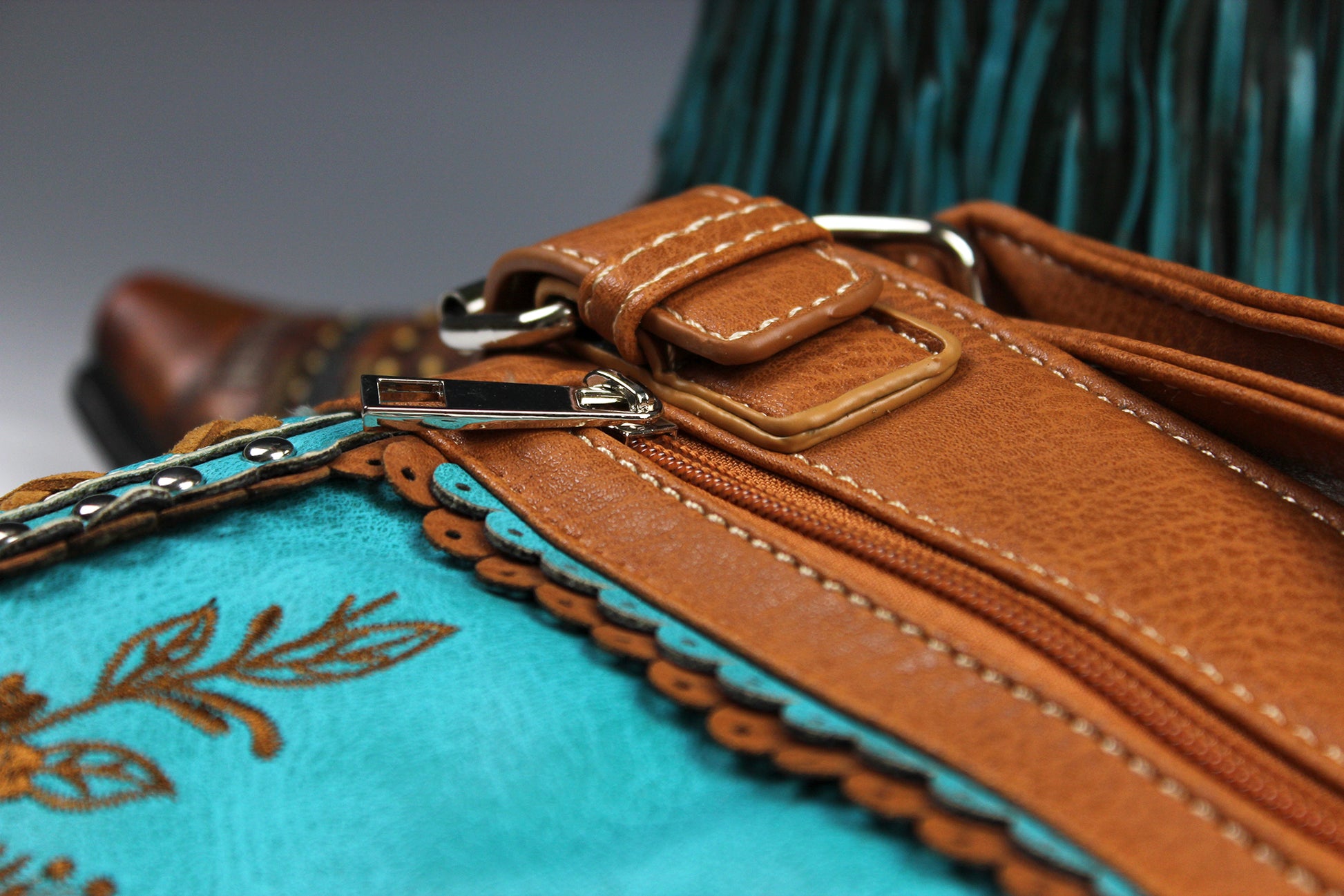 The Montana Shoulder Bag - turquoise & brown western cowgirl style bag with intricate detailing and cross motif with an internal zip pocket