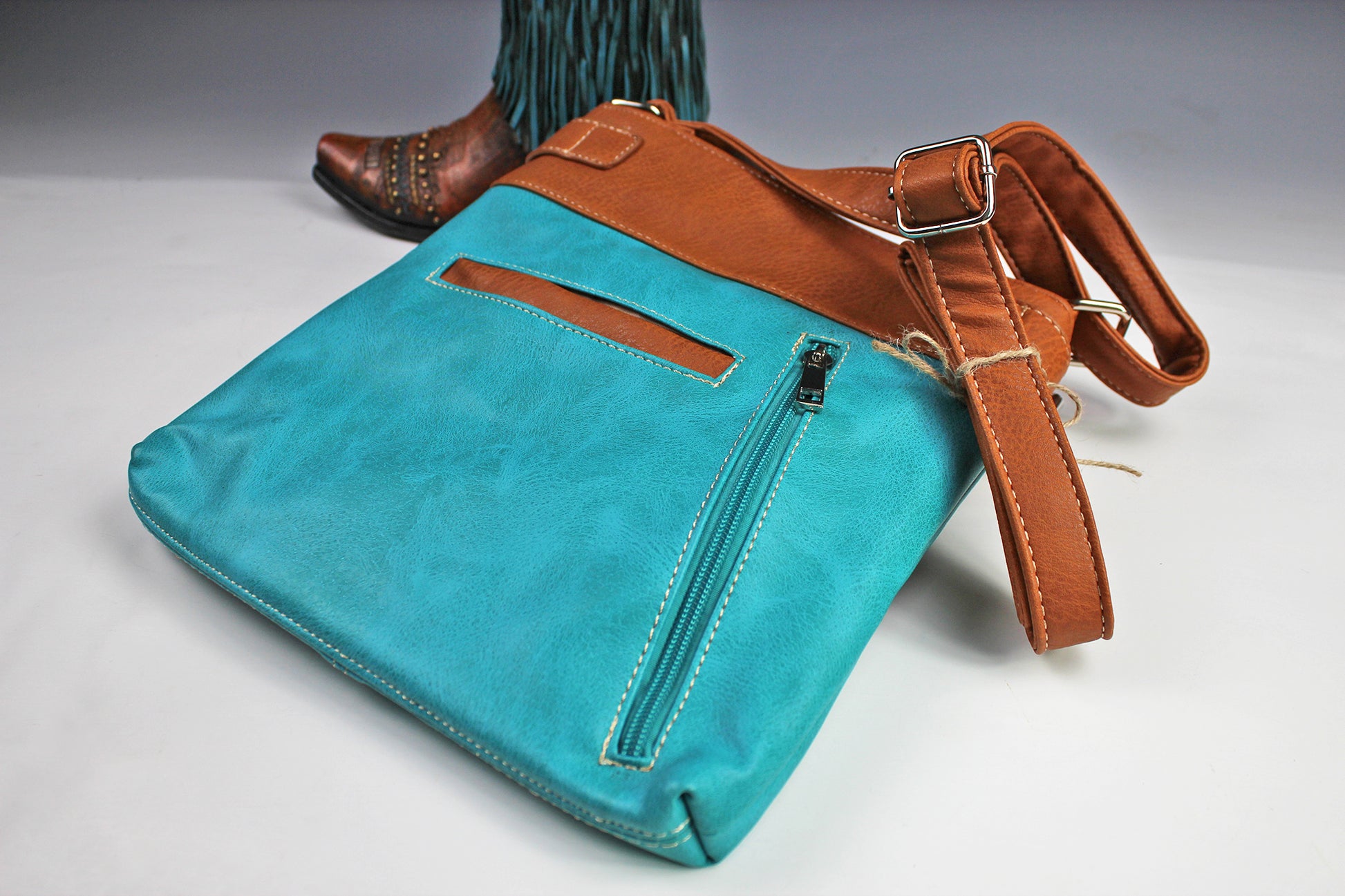 The Montana Shoulder Bag - turquoise & brown western cowgirl style bag with intricate detailing and cross motif with an internal zip pocket
