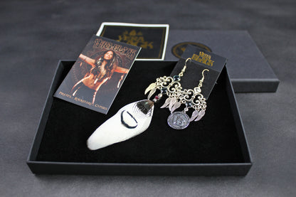 Earring set with packaging on a dark surface