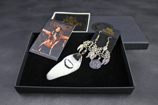 Earring set with packaging on a dark surface
