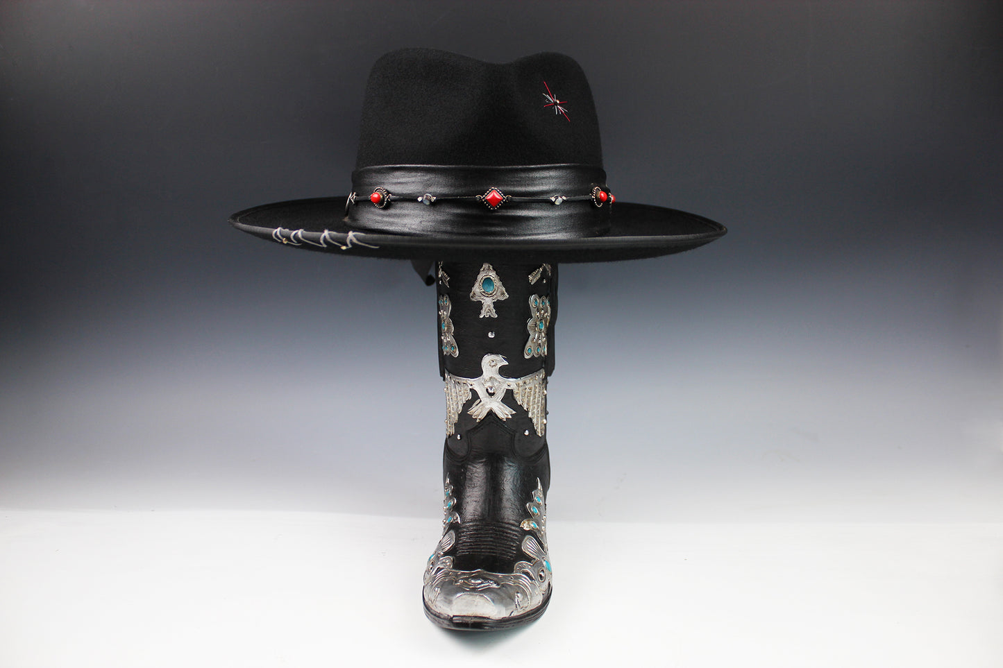 Black cowboy hat with decorative elements on a gray background
