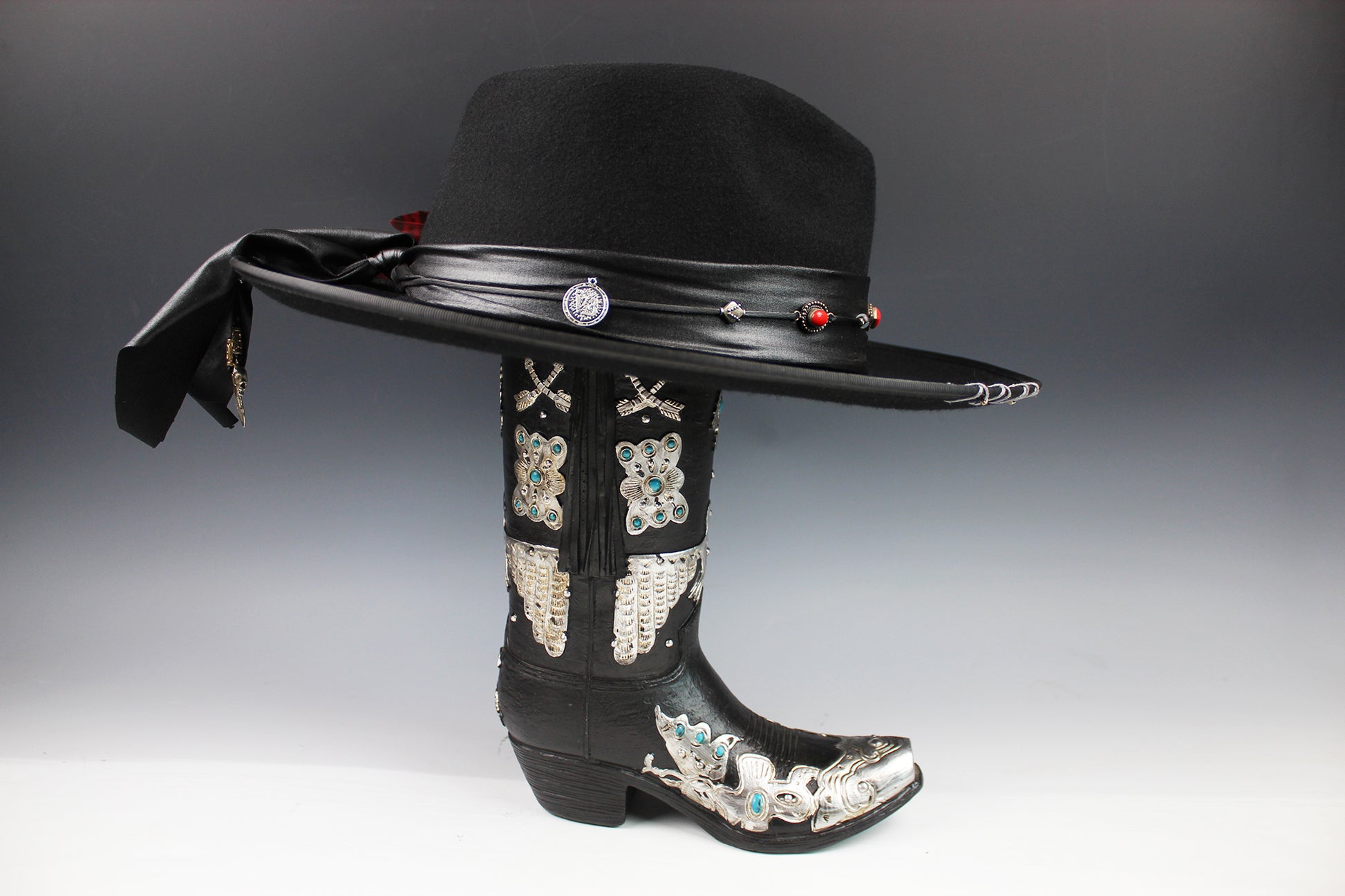 Black cowboy hat with decorative elements on a gray background