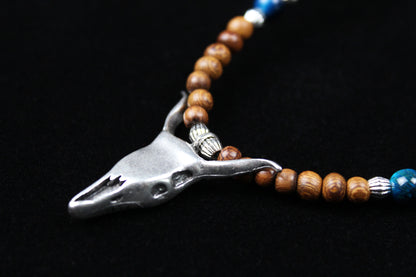 The Wyoming Necklace, Detailed with howlite, madre de cacao, blue/green tiger's eye and silver beading, all of this leading to a very cool ram's head pendant.