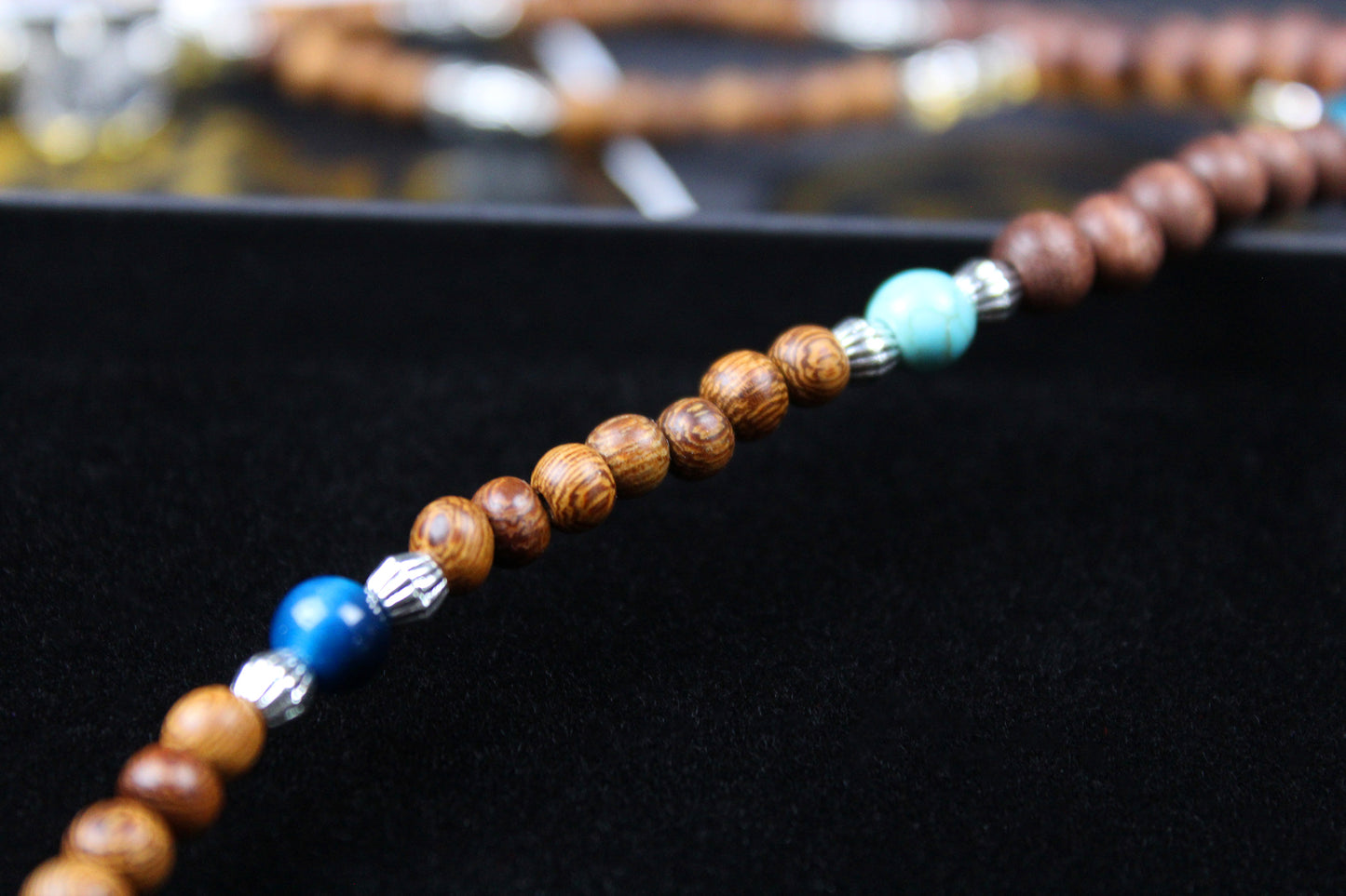 The Wyoming Necklace, Detailed with howlite, madre de cacao, blue/green tiger's eye and silver beading, all of this leading to a very cool ram's head pendant.