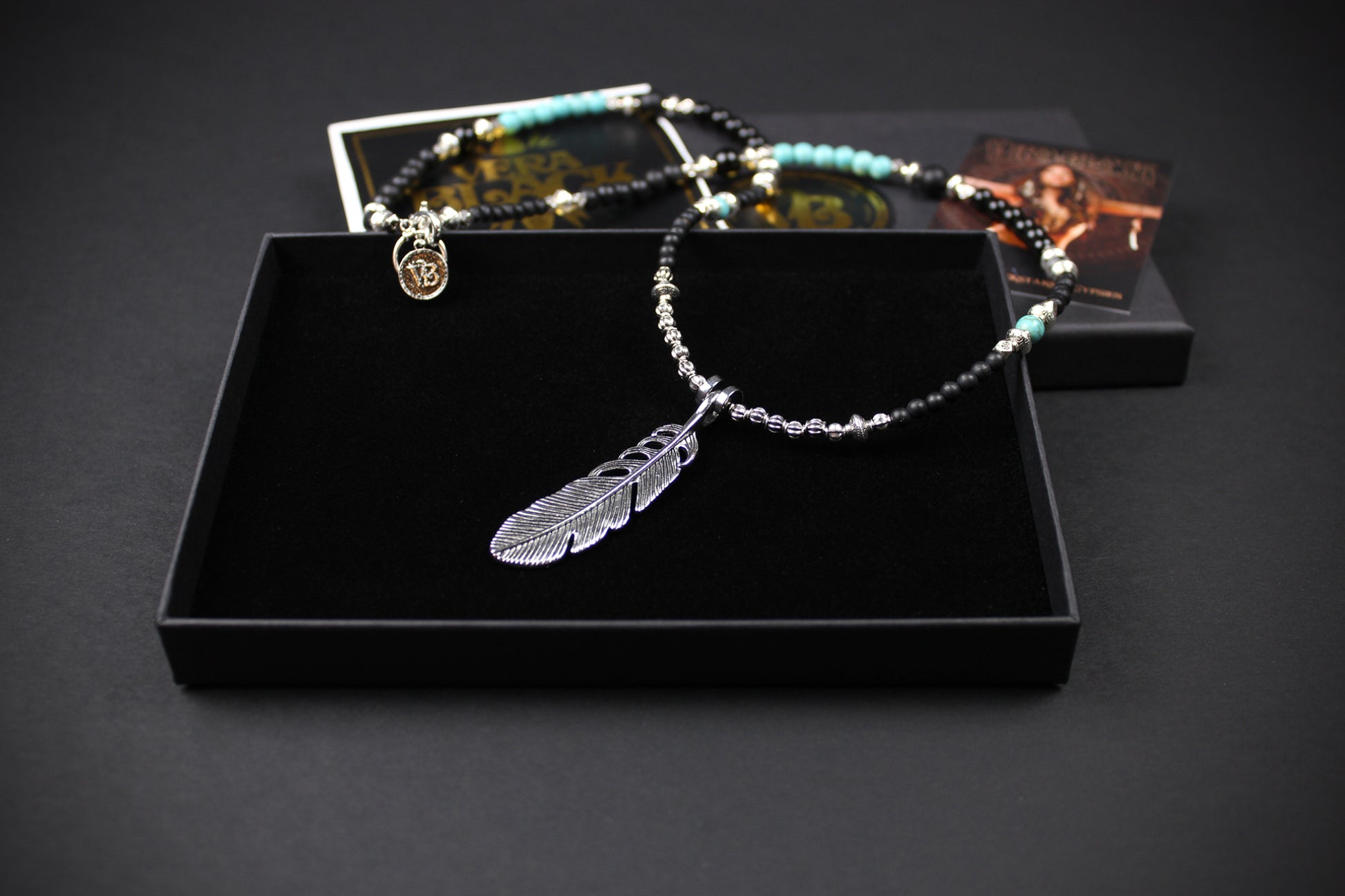 The Little Wing Necklace. Detailed with hematite, howlite, black wood beads and silver beading, all of this leading to a very cool feather pendant.