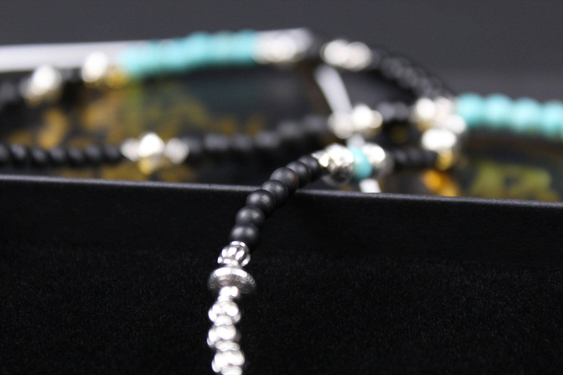 The Little Wing Necklace. Detailed with hematite, howlite, black wood beads and silver beading, all of this leading to a very cool feather pendant.
