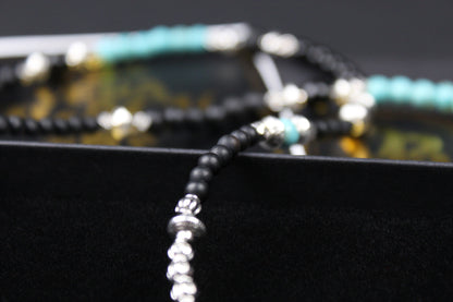 The Little Wing Necklace. Detailed with hematite, howlite, black wood beads and silver beading, all of this leading to a very cool feather pendant.