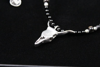 The Buffalo Smoke Necklace : Unisex Beaded Necklace Detailed with hematite, howlite, matte agate, lava stone, black onyx and silver beading, all of this leading to a very cool ram's head pendant.