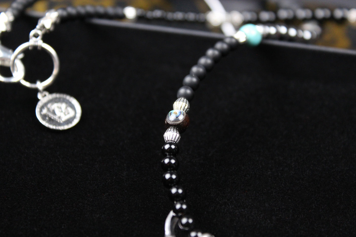 The Buffalo Smoke Necklace : Unisex Beaded Necklace Detailed with hematite, howlite, matte agate, lava stone, black onyx and silver beading, all of this leading to a very cool ram's head pendant.
