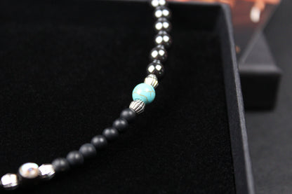 The Buffalo Smoke Necklace : Unisex Beaded Necklace Detailed with hematite, howlite, matte agate, lava stone, black onyx and silver beading, all of this leading to a very cool ram's head pendant.