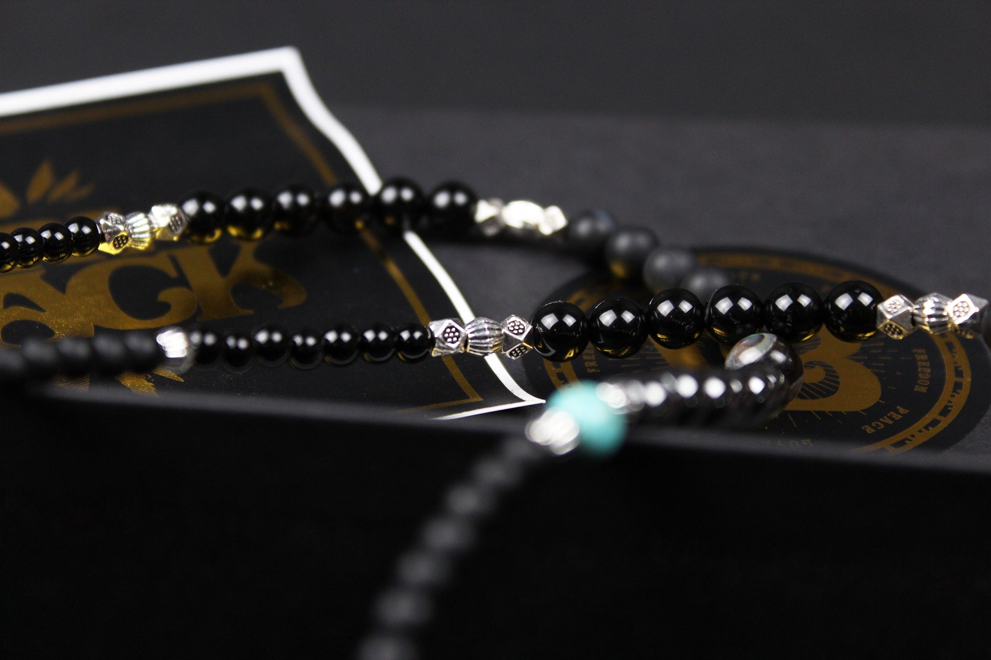 The Buffalo Smoke Necklace : Unisex Beaded Necklace Detailed with hematite, howlite, matte agate, lava stone, black onyx and silver beading, all of this leading to a very cool ram's head pendant.