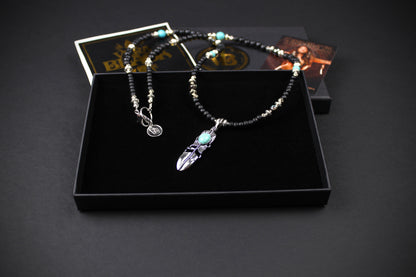 The Blue Wing Necklace, Detailed with hematite, howlite, black wood beads and silver beading, all of this leading to a very cool feather pendant.