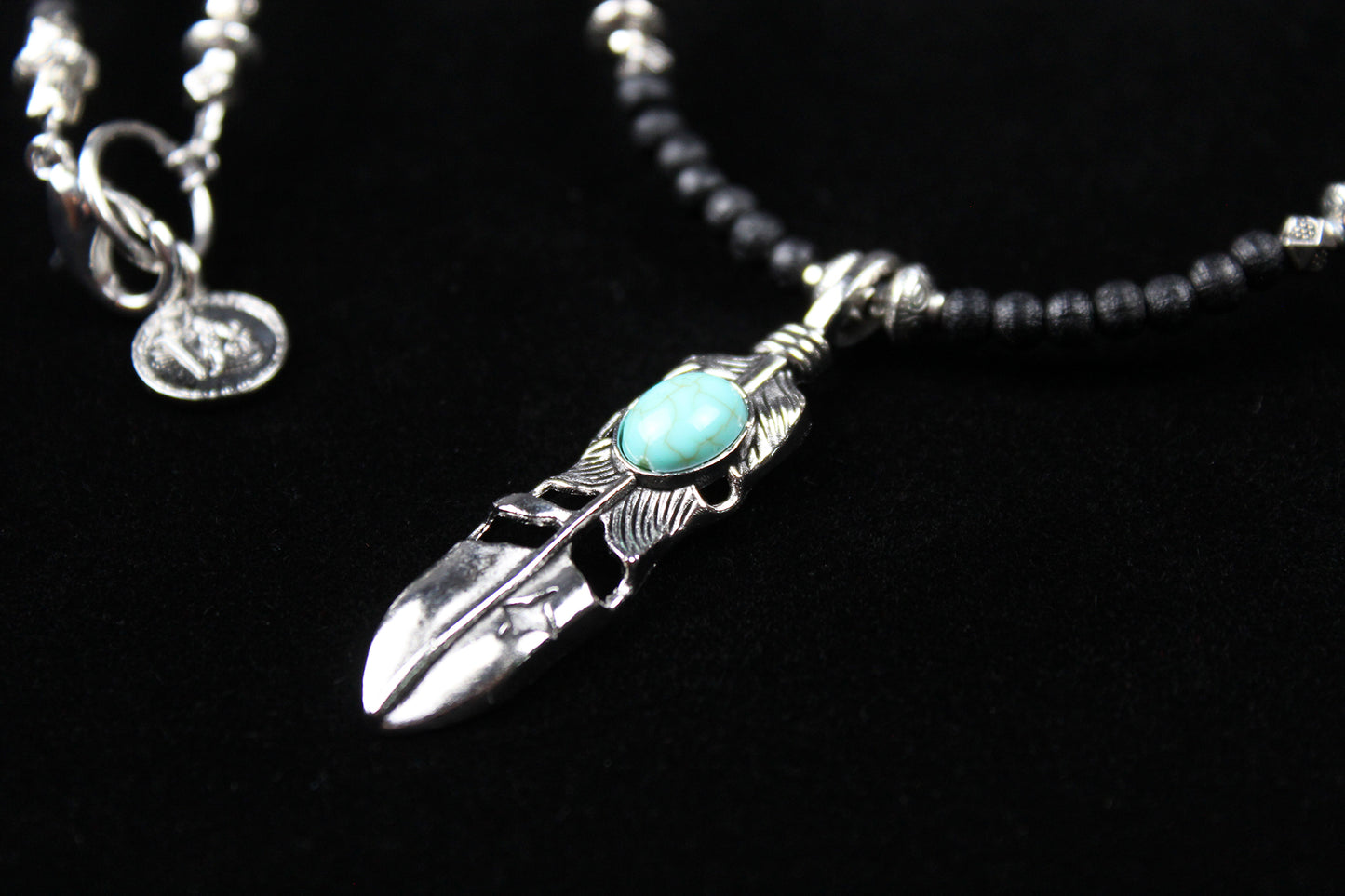 The Blue Wing Necklace, Detailed with hematite, howlite, black wood beads and silver beading, all of this leading to a very cool feather pendant.