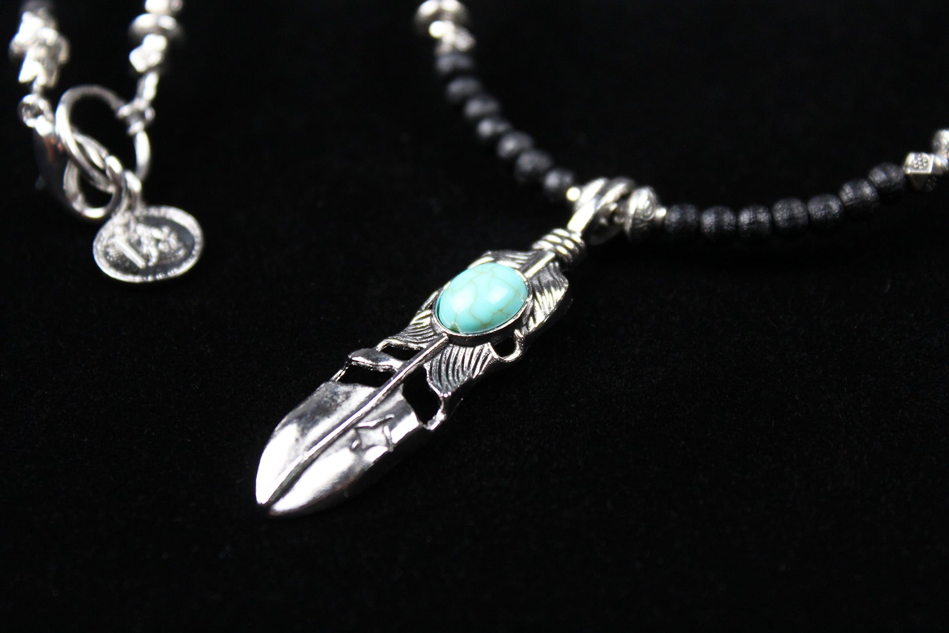 The Blue Wing Necklace, Detailed with hematite, howlite, black wood beads and silver beading, all of this leading to a very cool feather pendant.