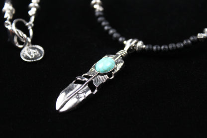 The Blue Wing Necklace, Detailed with hematite, howlite, black wood beads and silver beading, all of this leading to a very cool feather pendant.