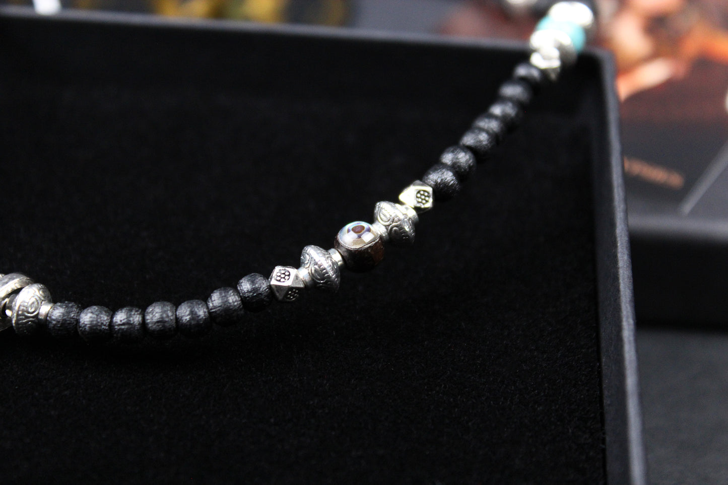 The Blue Wing Necklace, Detailed with hematite, howlite, black wood beads and silver beading, all of this leading to a very cool feather pendant.