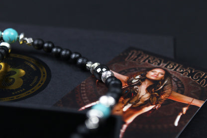 The Blue Wing Necklace, Detailed with hematite, howlite, black wood beads and silver beading, all of this leading to a very cool feather pendant.