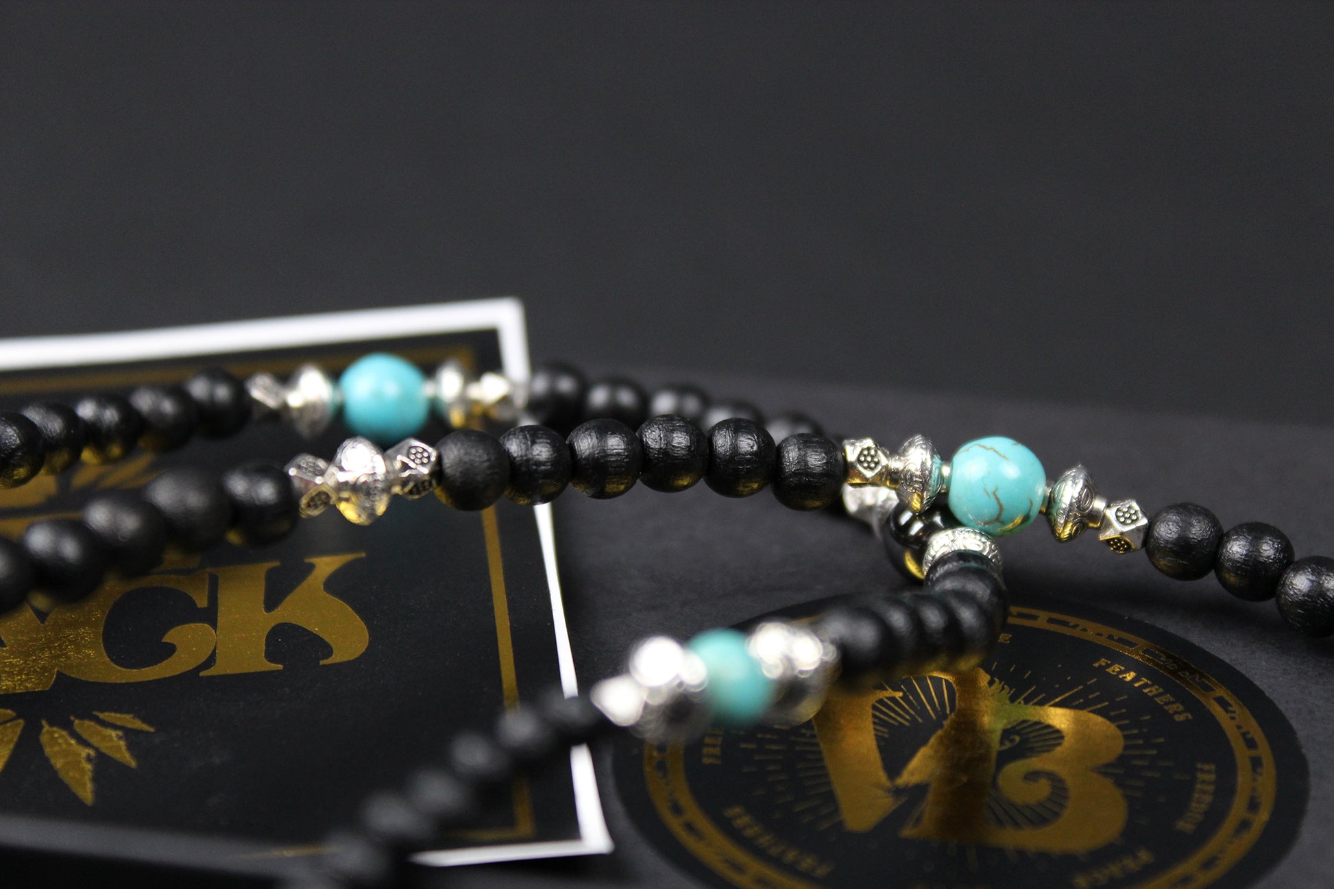 The Blue Wing Necklace, Detailed with hematite, howlite, black wood beads and silver beading, all of this leading to a very cool feather pendant.