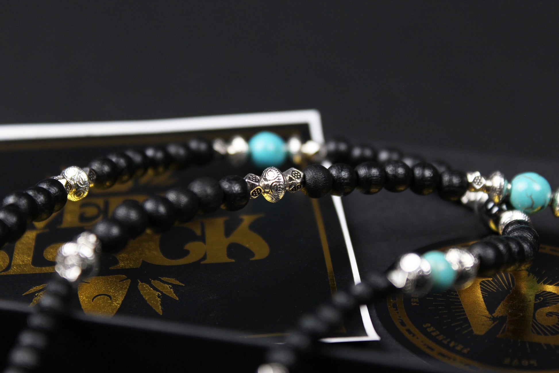The Blue Wing Necklace, Detailed with hematite, howlite, black wood beads and silver beading, all of this leading to a very cool feather pendant.
