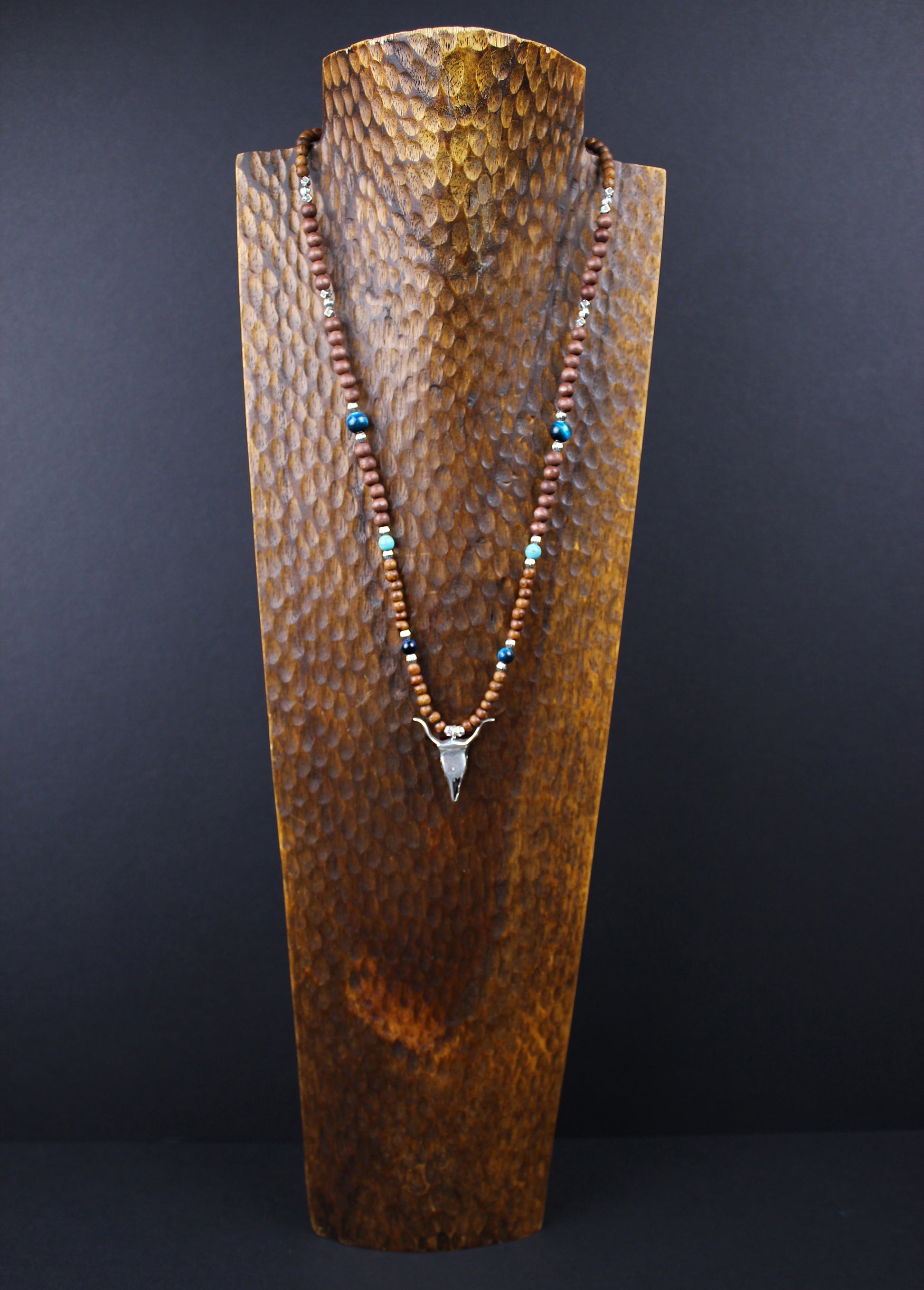 The Wyoming Necklace, Detailed with howlite, madre de cacao, blue/green tiger's eye and silver beading, all of this leading to a very cool ram's head pendant.